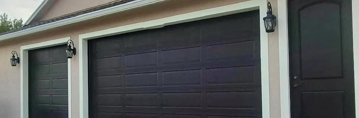 After: the same garage doors and side door repainted a deep brown with crisp trim