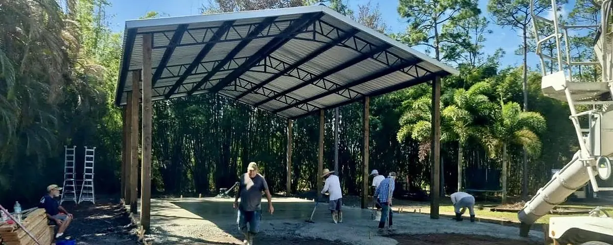Concrete slab poured under an open pole barn frame