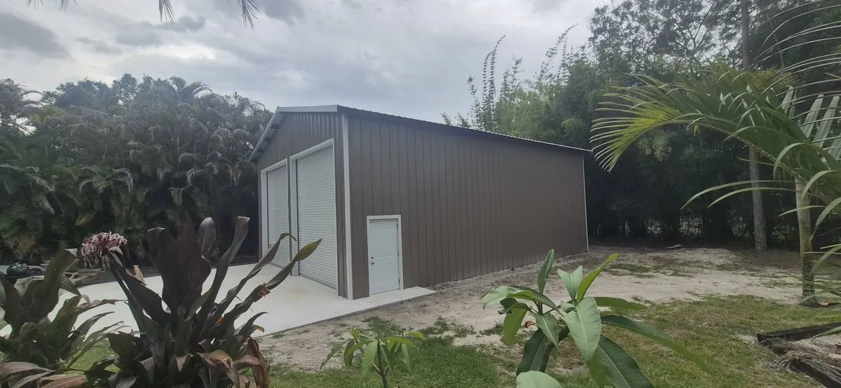 Side of the pole barn with a walk-in door