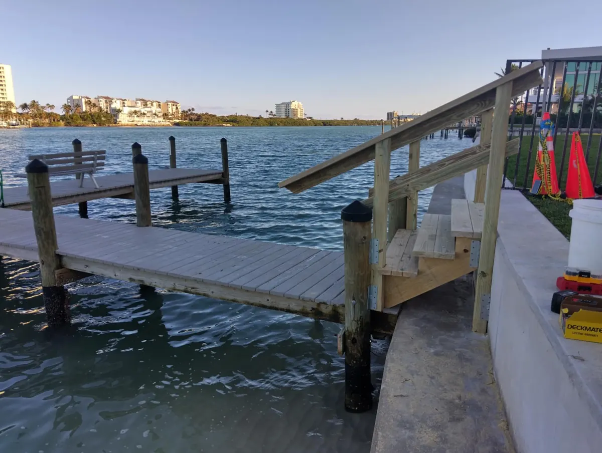 Dock and stairs on open water with the skyline behind
