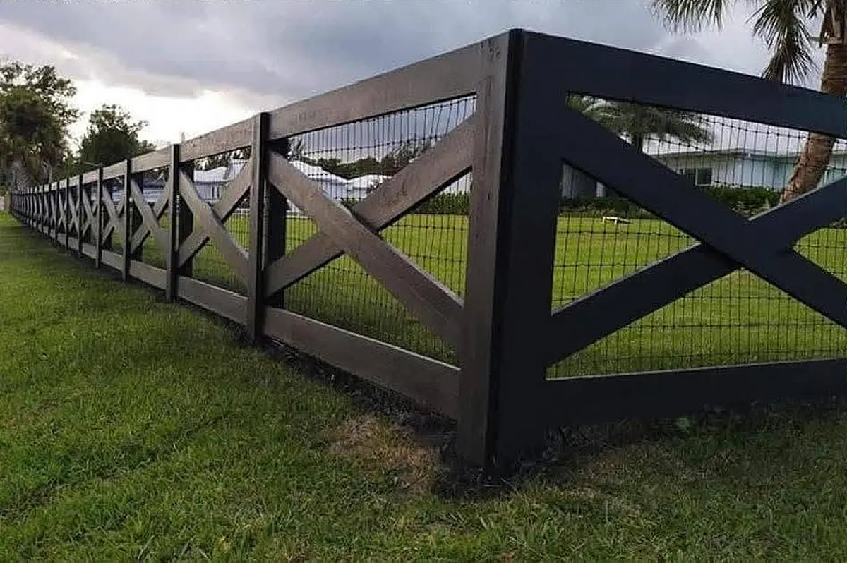 Black cross-buck farm fence with wire mesh