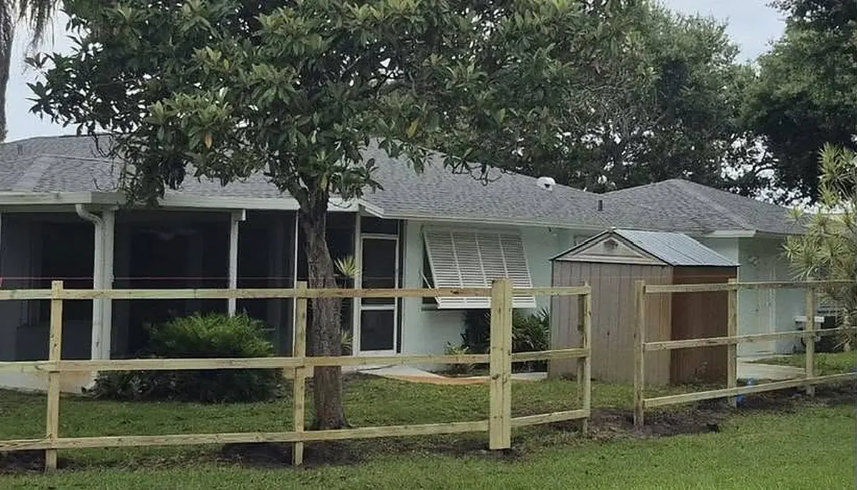 Split rail fence across a front yard