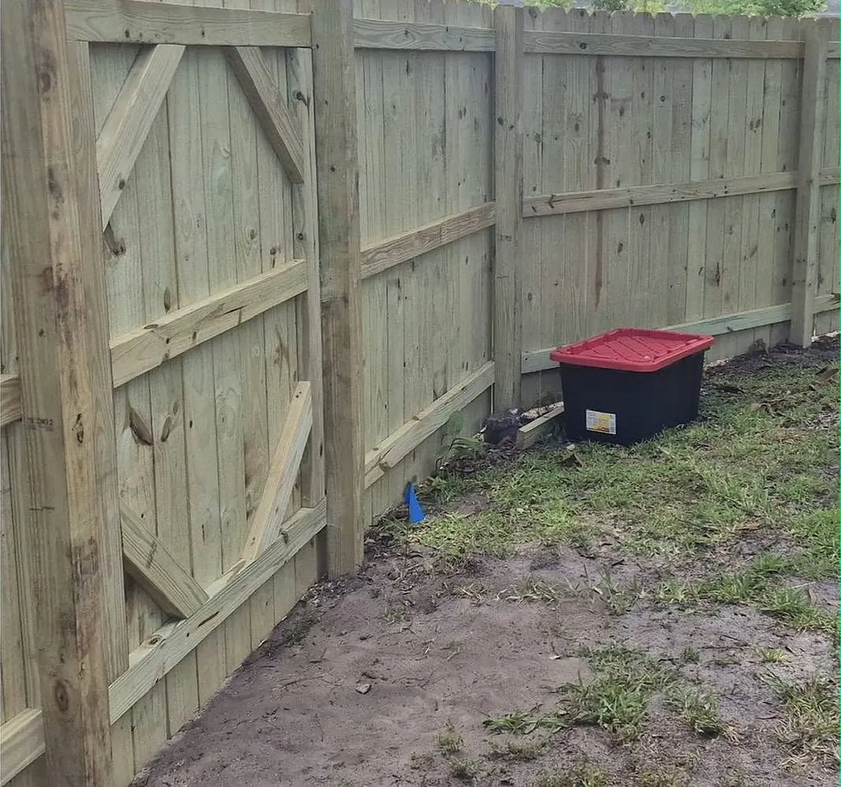 Gate on a dog-ear privacy fence with a diagonal brace that keeps it square