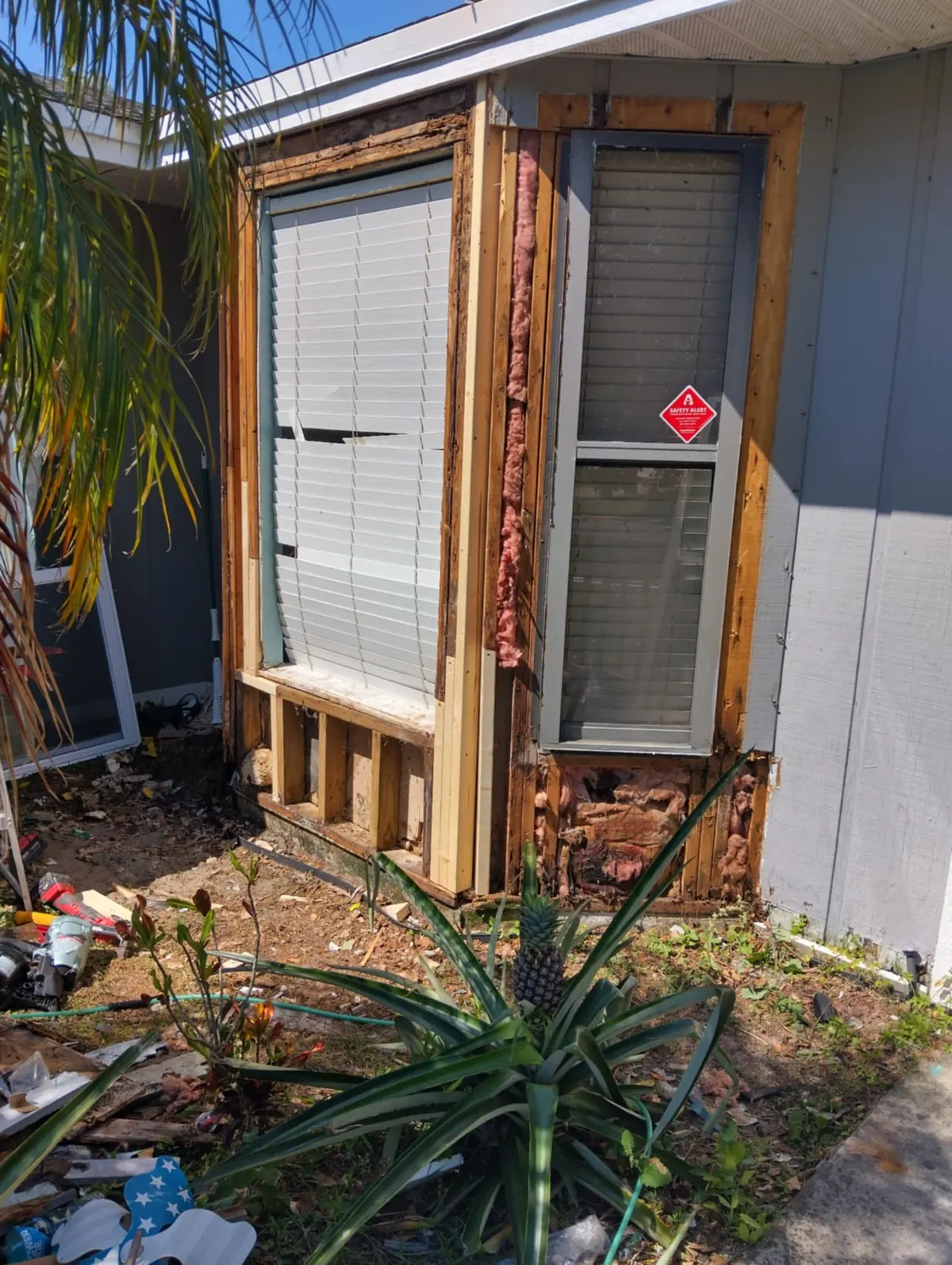 Rotted framing around a window opened up before new siding